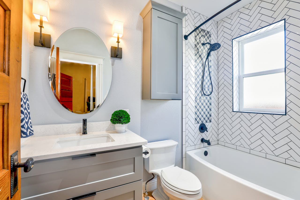 Bathroom shower with blue and white tiles.